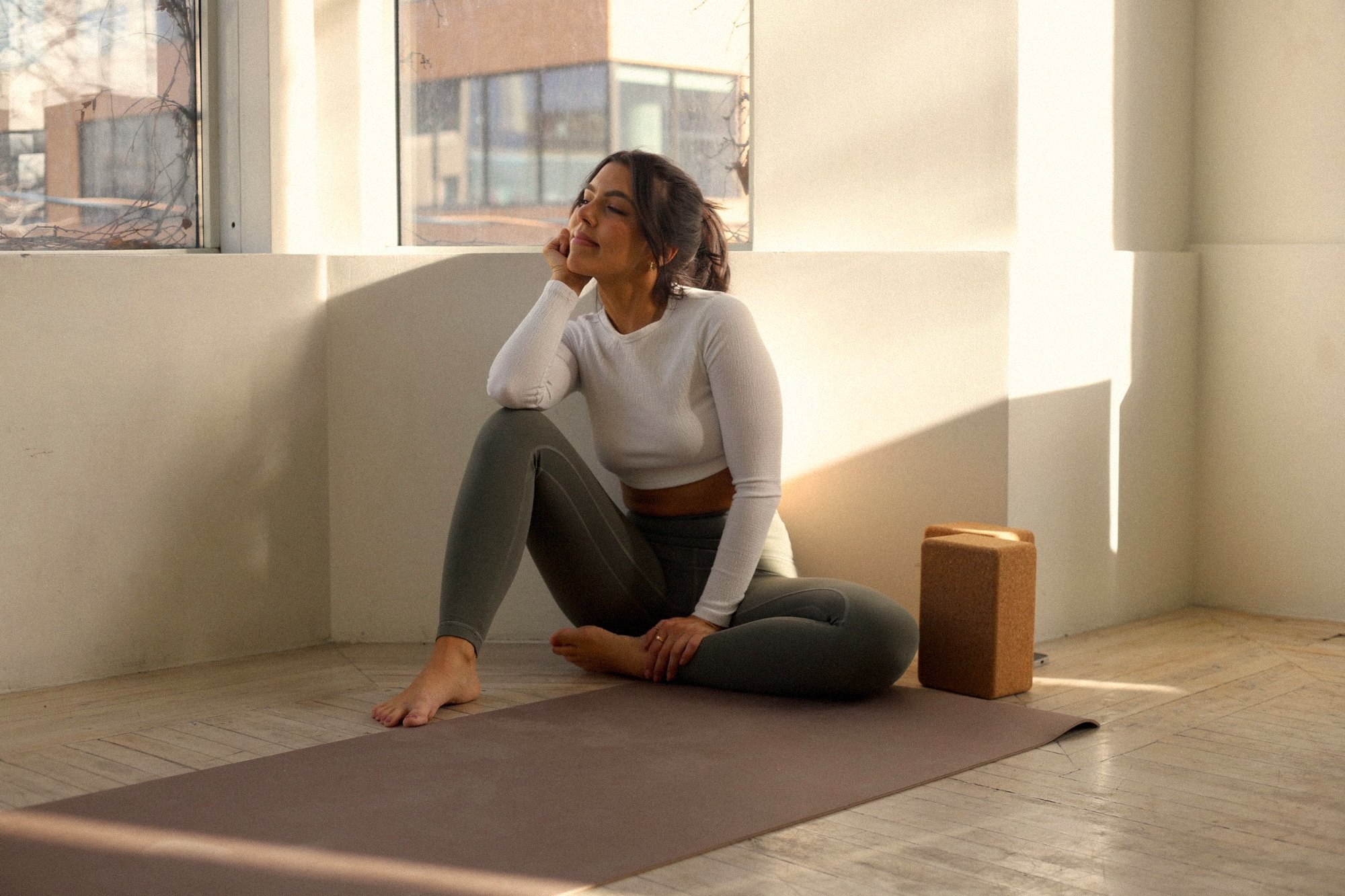 Melo, Toronto yoga teacher, stretching in warm morning light at home